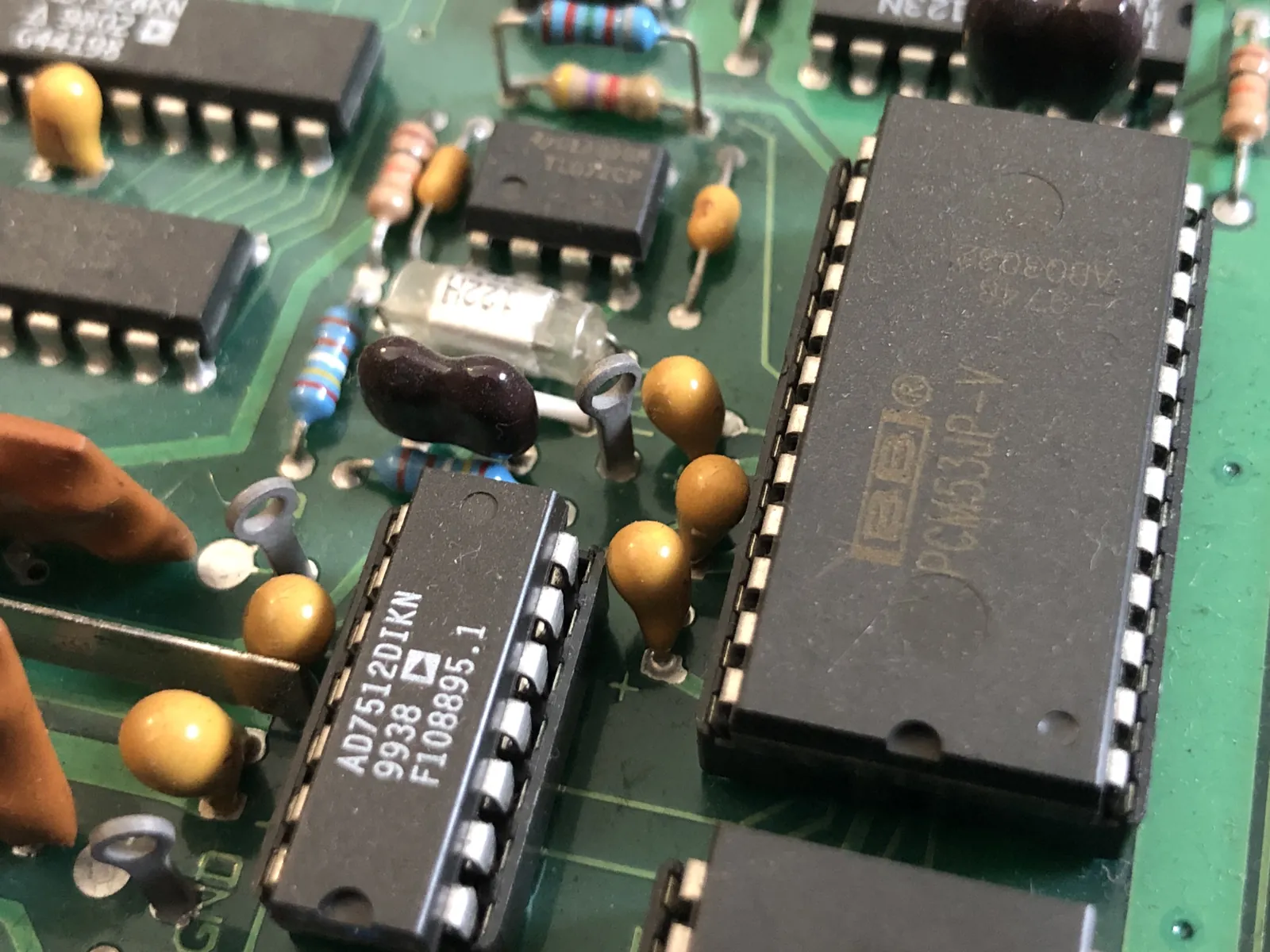 A long chip with the BB logo and PCM53JP-V marking. An AD7512DIKN chip is in front on the left.